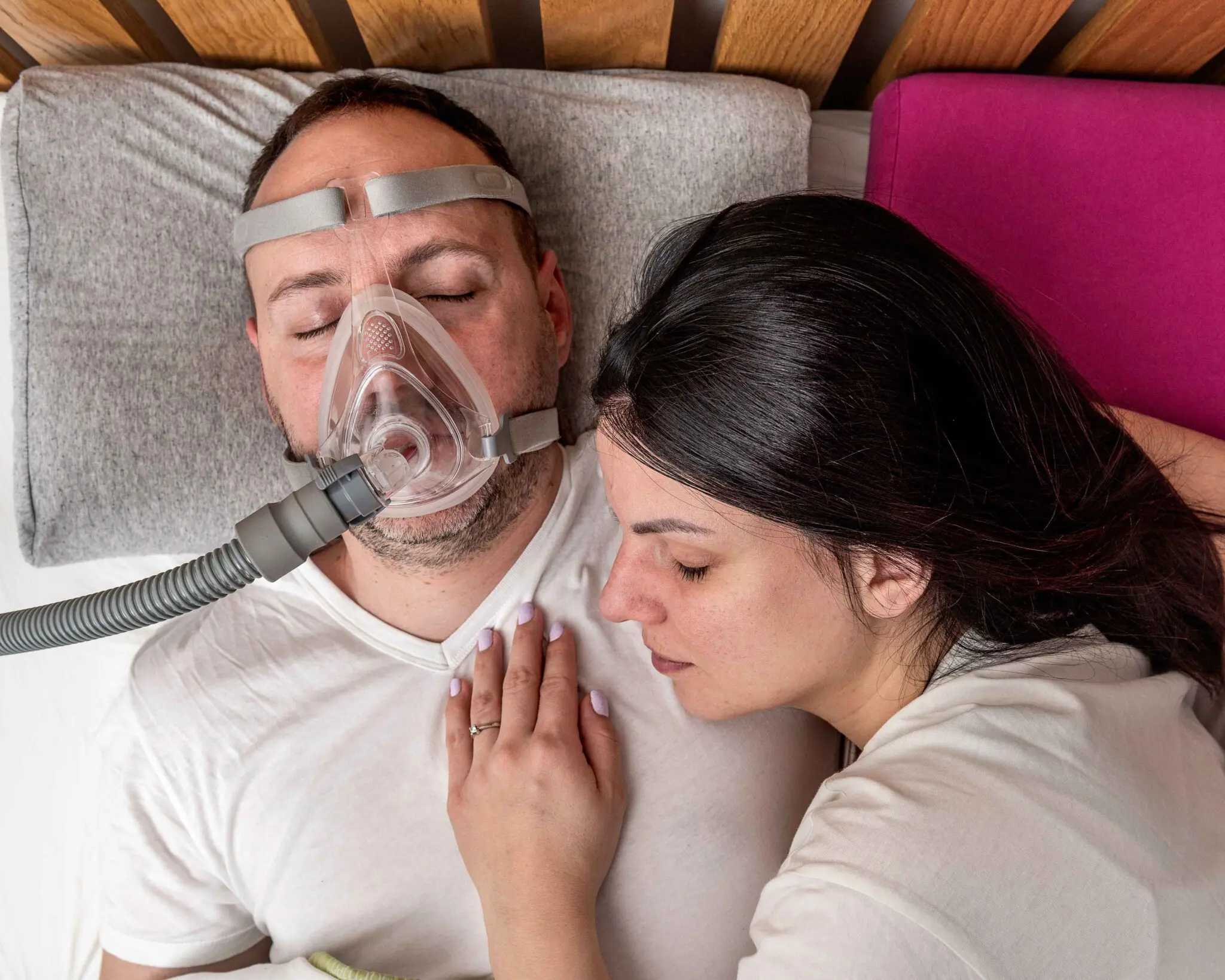 cffba223938364aaed31813798db03cc_11zon A man and woman laying in bed with their head on the pillow.