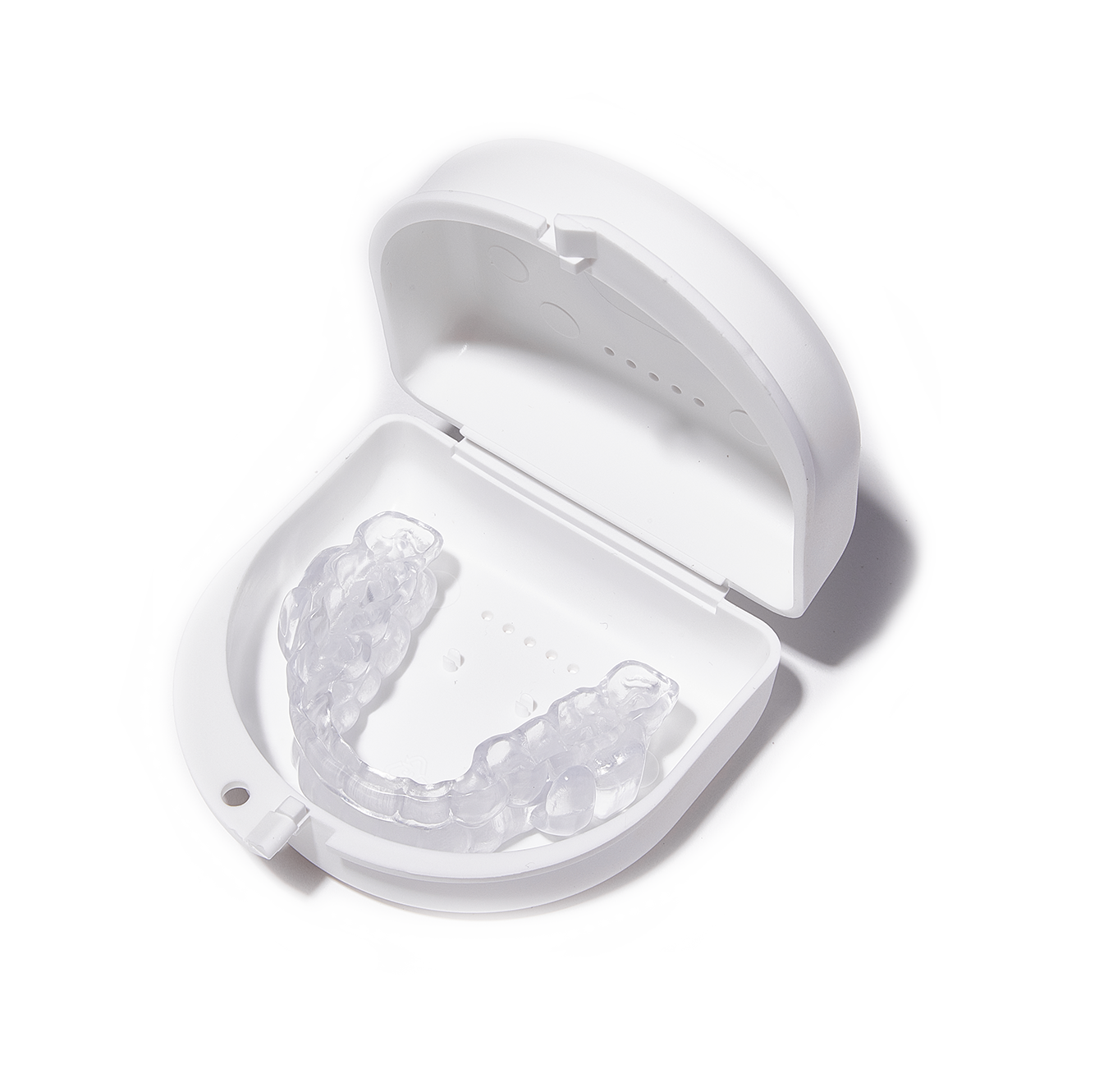 68025db70a22f_ProSomnus_Case_1 A white plastic container with a mouth guard on it.